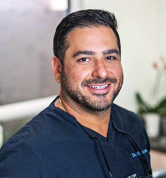 West Palm Beach dentist Doctor Mihran Asinmaz smiling with his arms crossed